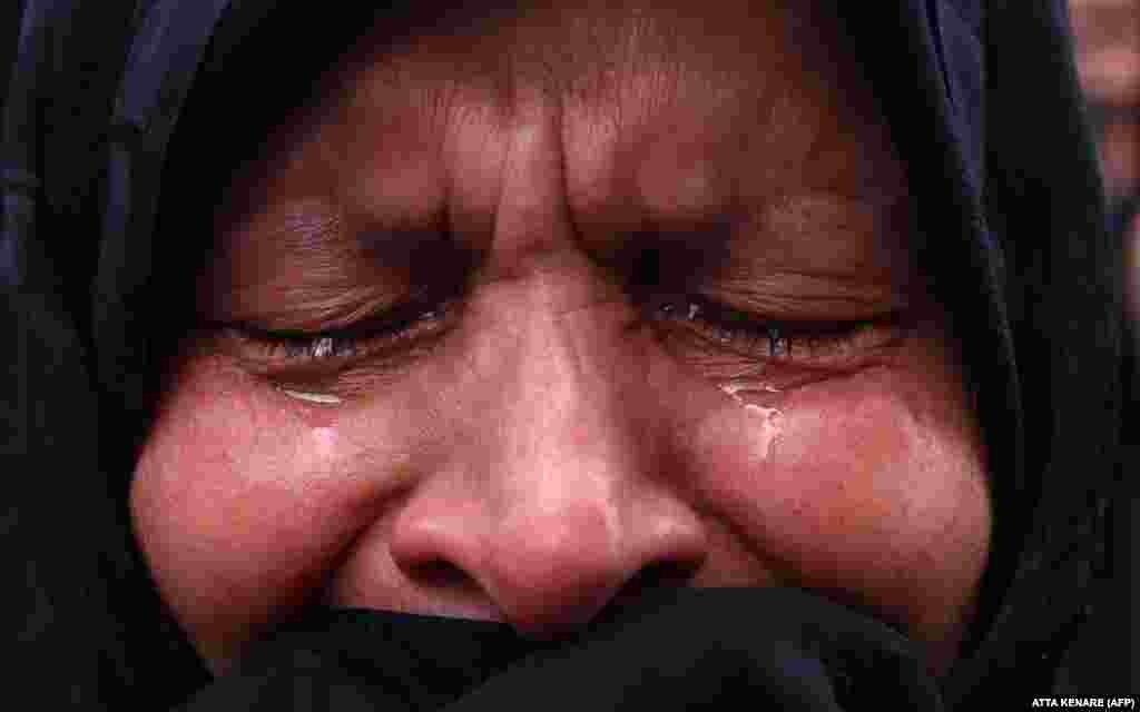 A woman mourns the death of Raisi in Tehran's Vali-Asr Square.