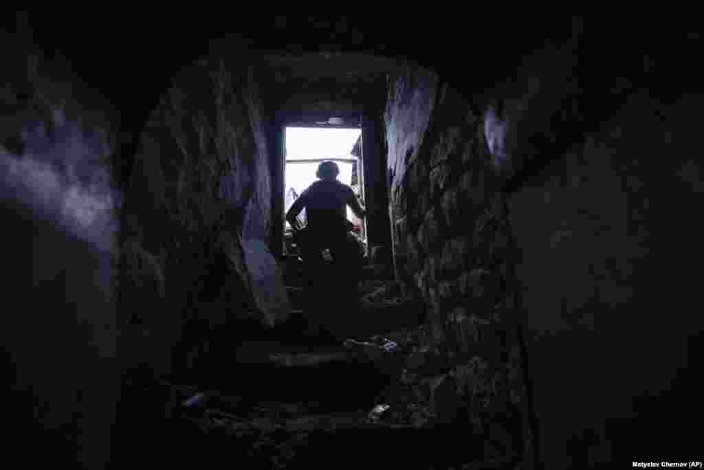 A Ukrainian soldier takes cover. The brigade went house to house, taking Russian prisoners and killing those who fought back. Even after the last of the Russian forces were expelled, Andriyivka came under constant shelling, with buzzing drones on both sides.