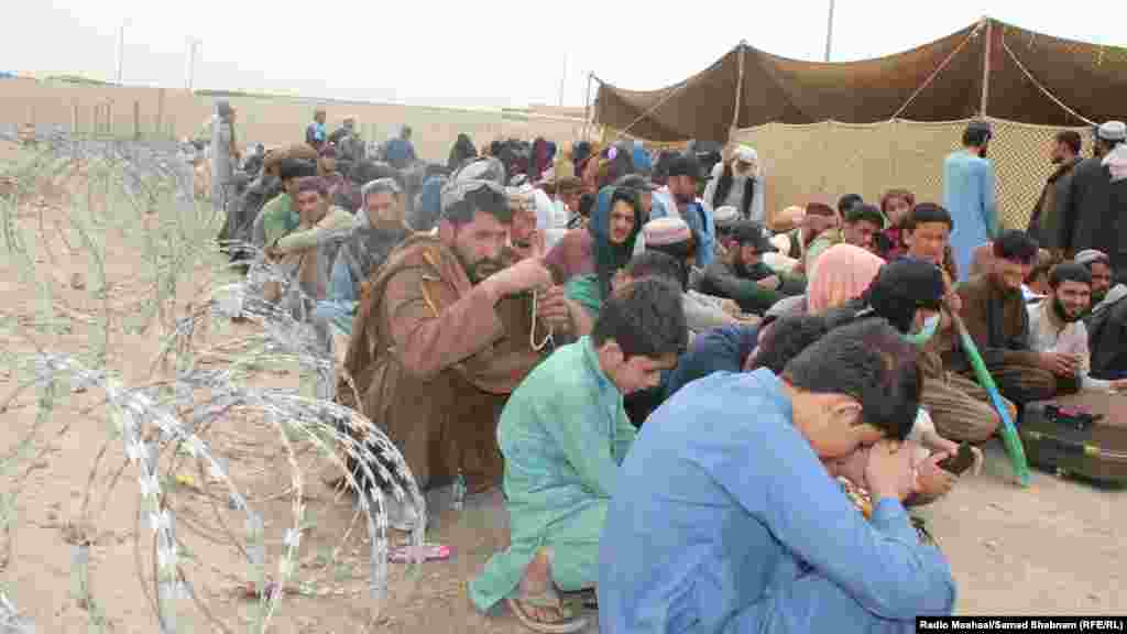 Afghan citizens wait at a holding center set up at the Chaman border crossing along the Pakistan-Afghanistan border in Pakistan's Balochistan Province on November 2. Thousands of Afghans are seeking to cross into Afghanistan following Islamabad's announcement that all undocumented immigrants in Pakistan must leave the country or face arrest. 