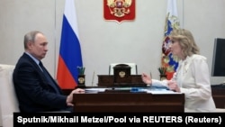 Russian President Vladimir Putin (left) and his commissioner for children's rights, Maria Lvova-Belova, were included in an arrest warrant by the International Criminal Court over the deportation of Ukrainian children.