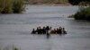 Migrants cross the Rio Grande river into the United States at Eagle Pass, Texas, in May.