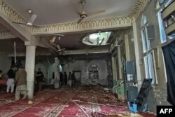 Security personnel inspect a mosque after a bomb blast in Peshawar on March 4.