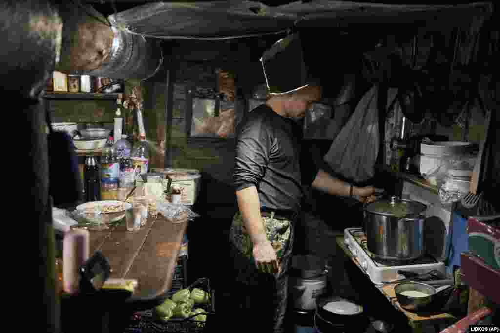 A Ukrainian soldier cooks in a shelter in Bakhmut. Then known as Artemivsk, the city was retaken from Russian-backed fighters in July 2014 by Ukrainian government forces. It was renamed Bakhmut in 2016 and had been largely rebuilt since then, serving as a key trading post and access point for people coming and going from parts of the Donbas that were controlled by Russian-backed militias.