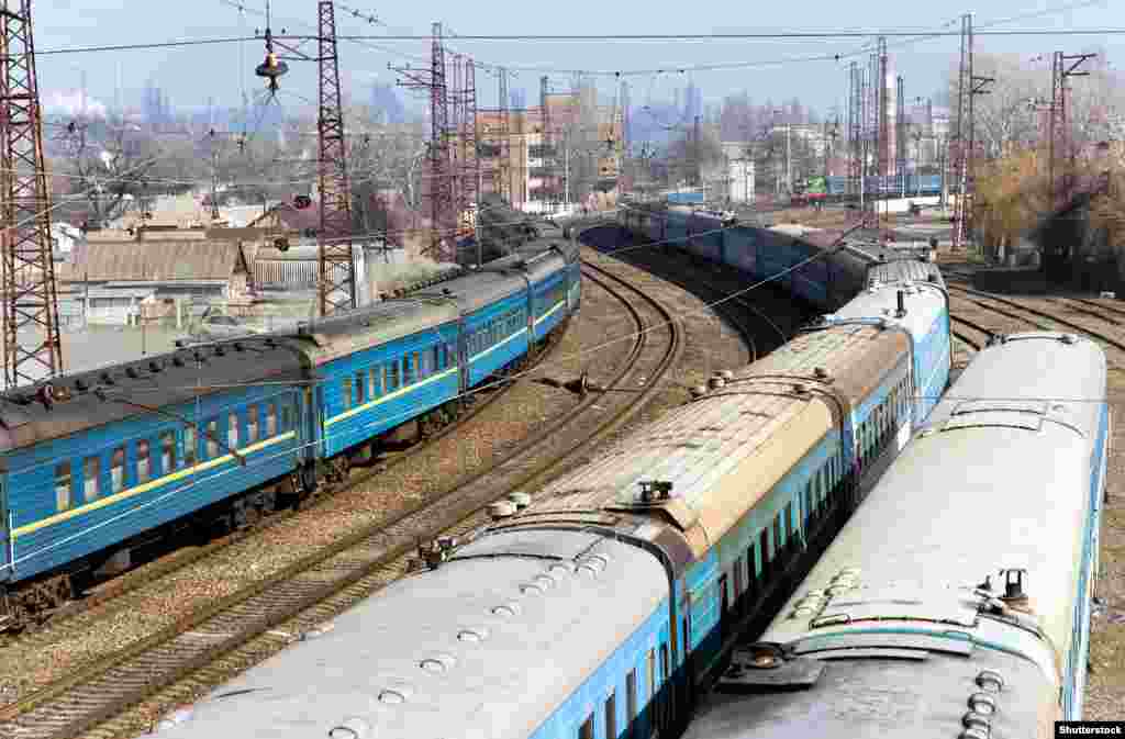 Trains on tracks that run alongside the coast near Mariupol station before the 2022 invasion. The Azovstal factory is visible in the background. 