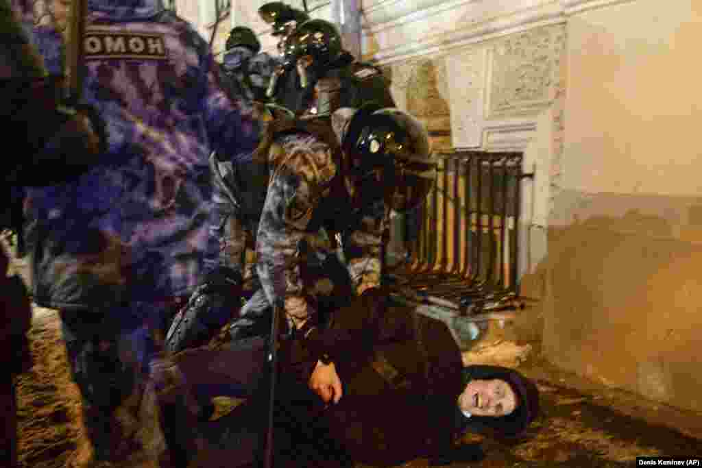 Police violently detain a man on Red Square in Moscow.
