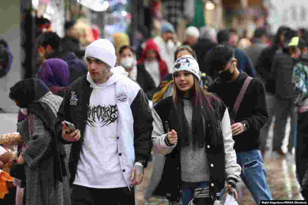 A couple in Tehran on December 6. A video published in early December shows two women walking down one of Tehran's central streets with their hair uncovered, a scene that was widely shared at the time but which now appears to be relatively common. 