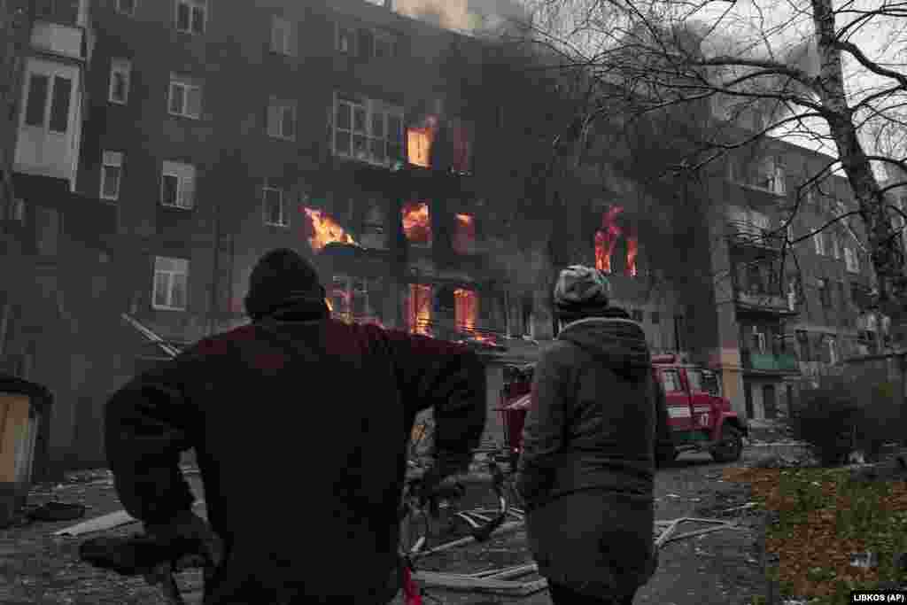 Local residents watch as their apartment burns following shelling on December 7. Before Russia's invasion, the city had a population of 70,000 and was known mostly for its large salt mine and vineyards.