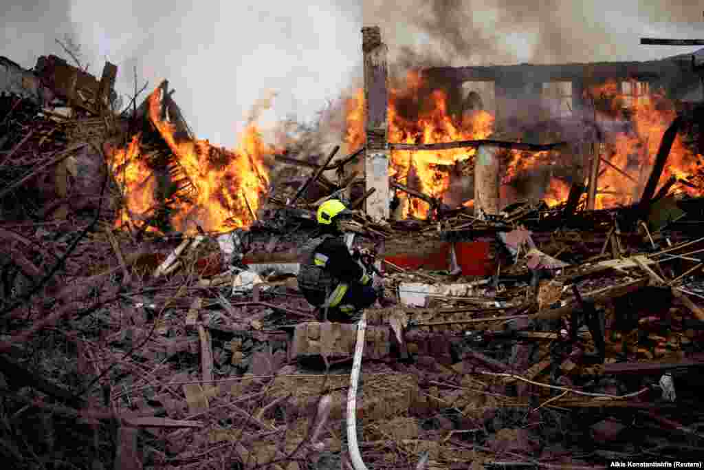 A firefighter works at the scene of a missile attack that impacted buildings near the Kharkiv airport on April 12. 
