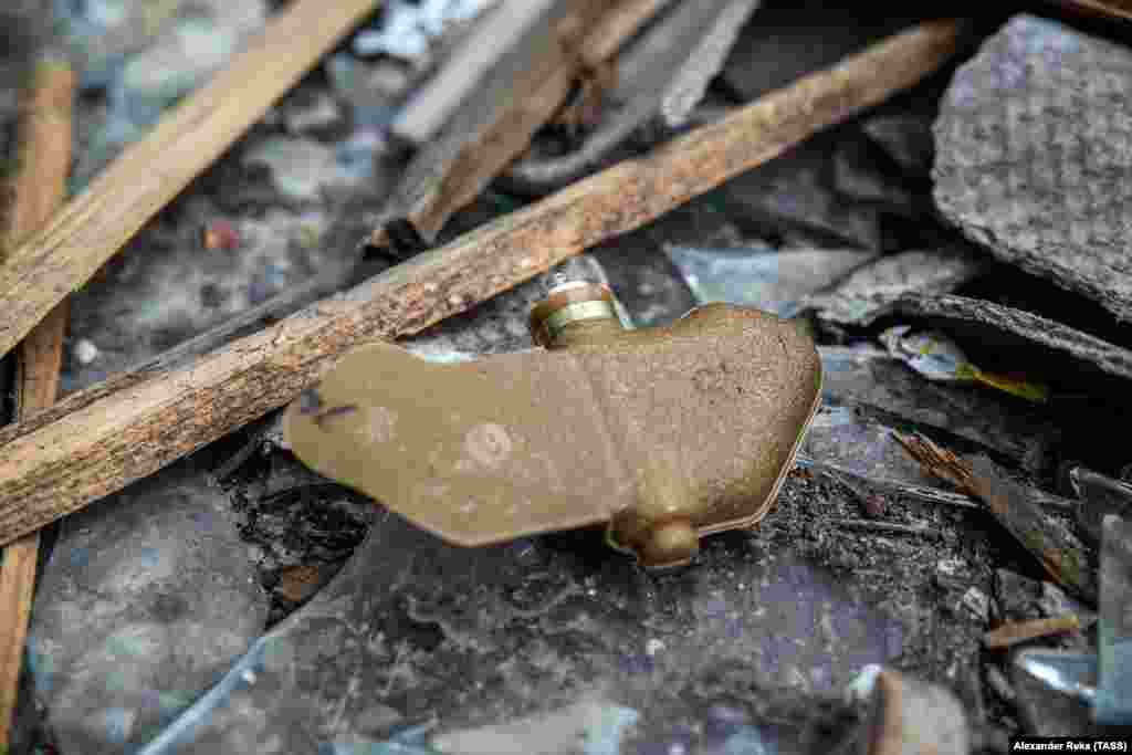A PFM-1 "butterfly mine" is seen in Popasnaya on April 11. The cellphone-sized mines are designed to be dropped from aircraft and spin slowly to the ground. Around 5 kilograms of pressure is sufficient to detonate the camouflaged anti-personnel mines. 