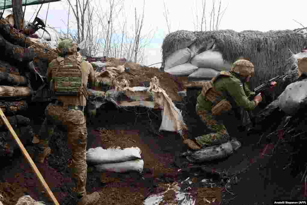 Ukrainian soldiers take positions in trenches in the Luhansk region on April 11. 