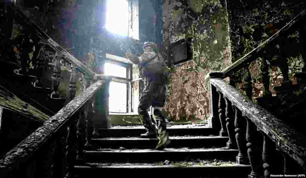 A Russian soldier climbs stairs at the destroyed Mariupol Drama Theater on April 12. The photo was taken during a press tour organized by the Russian military. 