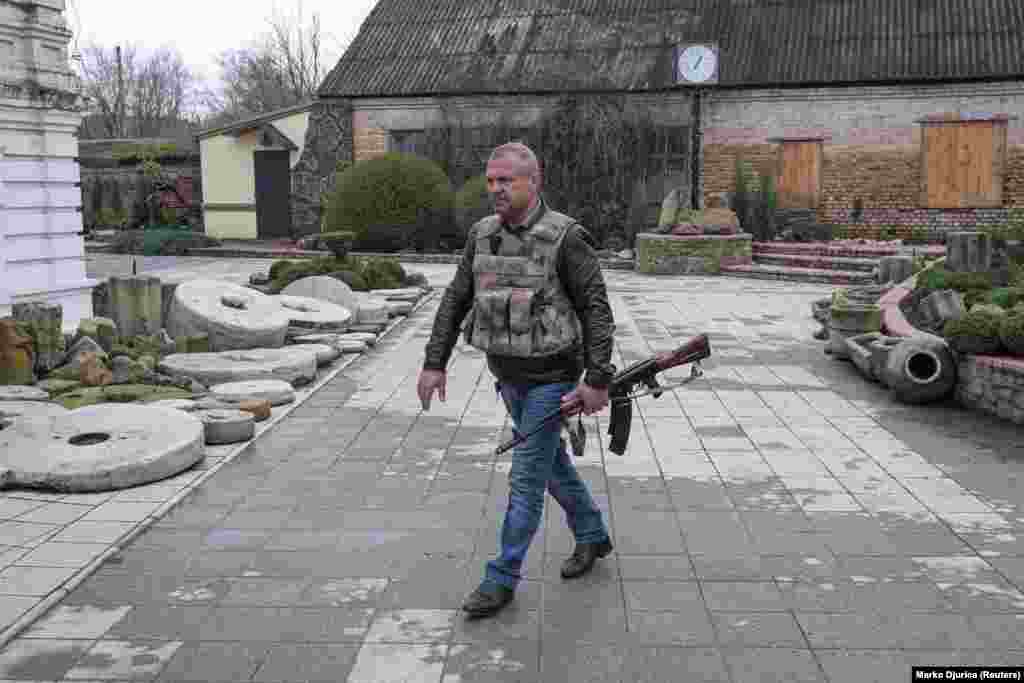 Balo Oleksandr, the mayor of the Ukrainian-held town of Barvinkove, is pictured carrying a weapon on April 12. 