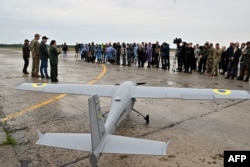 Journalists attend the presentation of a UJ-22 reconnaissance drone in the Kyiv region in August 2022.