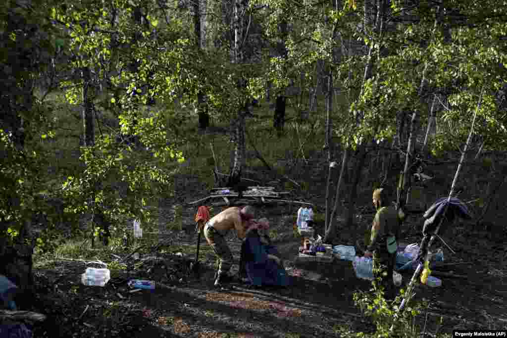 A Ukrainian soldier gets a haircut in a forest in the recently recaptured town of Lyman. The liberation of that key city is considered a major defeat for Russian forces.