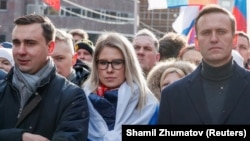 Russian opposition politicians Ivan Zhdanov (left to right), Lyubov Sobol, and Aleksei Navalny attend a rally in 2020 to mark the fifth anniversary of opposition politician Boris Nemtsov's assassination.