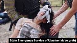 First responders help a victim of a Russian gliding bomb strike in Kharkiv that followed an especially massive and destructive overnight drone attack against the city on June 7.