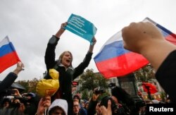 Supporters of Russian opposition leader Aleksei Navalny attend a rally in Moscow. The sign reads: "Freedom of elections, freedom to Navalny"