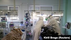 Medical specialists place the body of a person who died at the ICU unit for coronavirus patients in a bag at a hospital in Kalach-on-Don, Volgograd Region. November 14, 2021