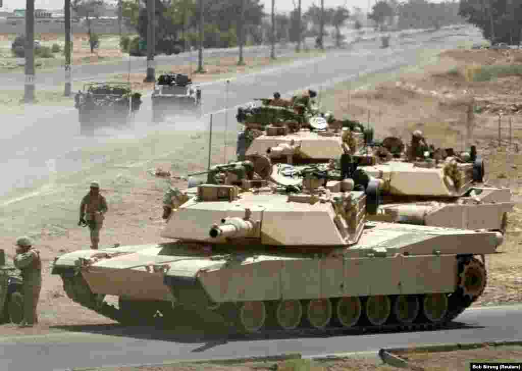 U.S. Marine Corps M1A1 Abrams tanks take up defensive positions during a firefight near the main traffic checkpoint in Fallujah, Iraq, on June 24, 2004. The export version of the Abrams is used by the armies of Australia, Egypt, Iraq, Kuwait, Poland, and Saudi Arabia. 
