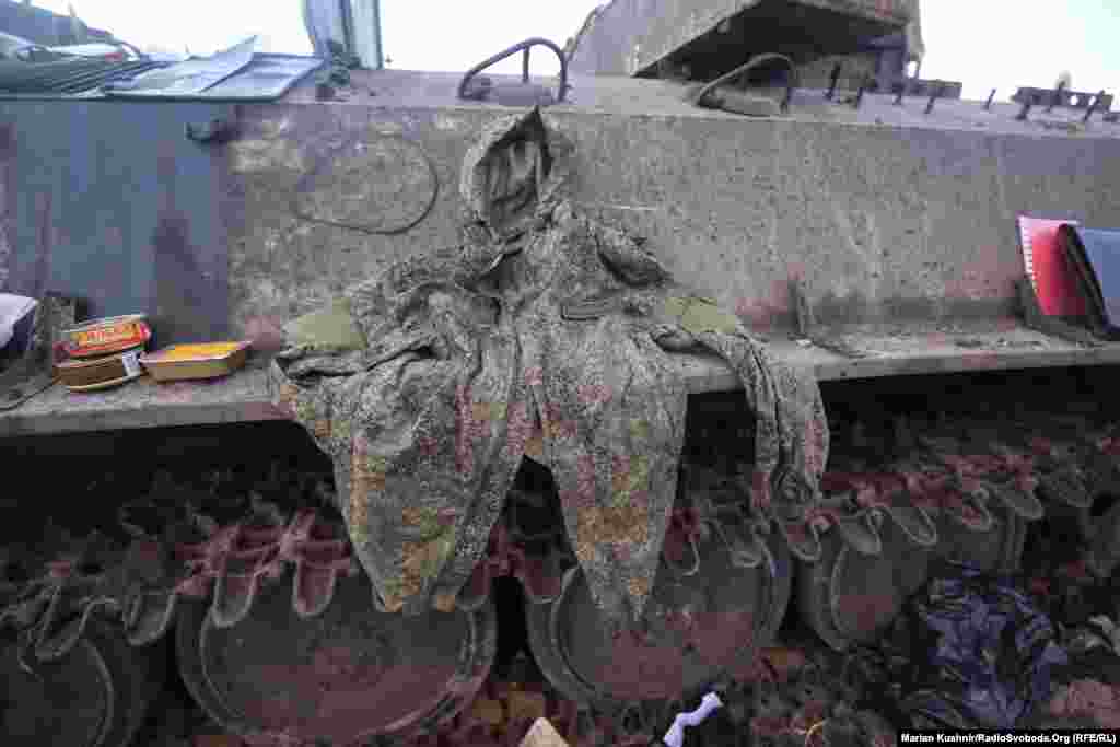 The jacket of an unidentified Russian soldier is spread on the side of an armored vehicle. 