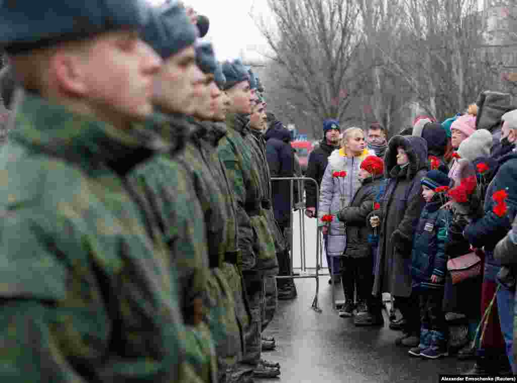 Local residents and cadets of the region controlled by a Russia-backed separatist group that calls itself the Donetsk People's Republic during a January 22 ceremony marking the fatal shelling of a trolleybus seven years earlier in Donetsk.