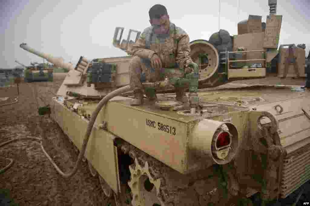 A U.S. Marine refuels his M1 Abrams tank at FOB Edinburgh in Helmand Province, Afghanistan on February 2, 2011. The current M1A2 Abrams can reach a top speed of 72 km/h (on paved roads) and 48 km/h off-road. The engine can use a variety of fuels, including jet fuel, gasoline, diesel, and marine diesel. 
