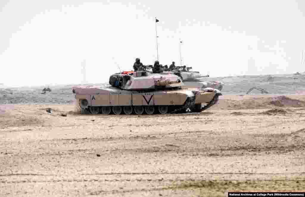 Two Marine Corps M-1A1 Abrams main battle tanks move across the desert during the ground phase of Operation Desert Storm on February 24, 1991. Though the M1 Abrams entered service in 1980, Desert Storm was its first time in combat. 
