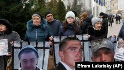 Relatives of Ukrainian prisoners held by the Russia-backed separatists display pictures of their loved in Kyiv in January. 