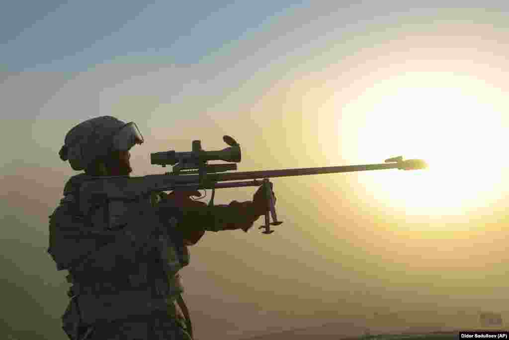 A Russian soldier aims his rifle. 