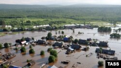 An aerial image of a village on June 26 shows a flash flood caused by heavy rains in the Irkutsk region.