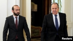 Russia - Russian Foreign Minister Sergei Lavrov and Armenian Foreign Minister Ararat Mirzoyan enter a hall during a meeting in Moscow, April 8, 2022. 