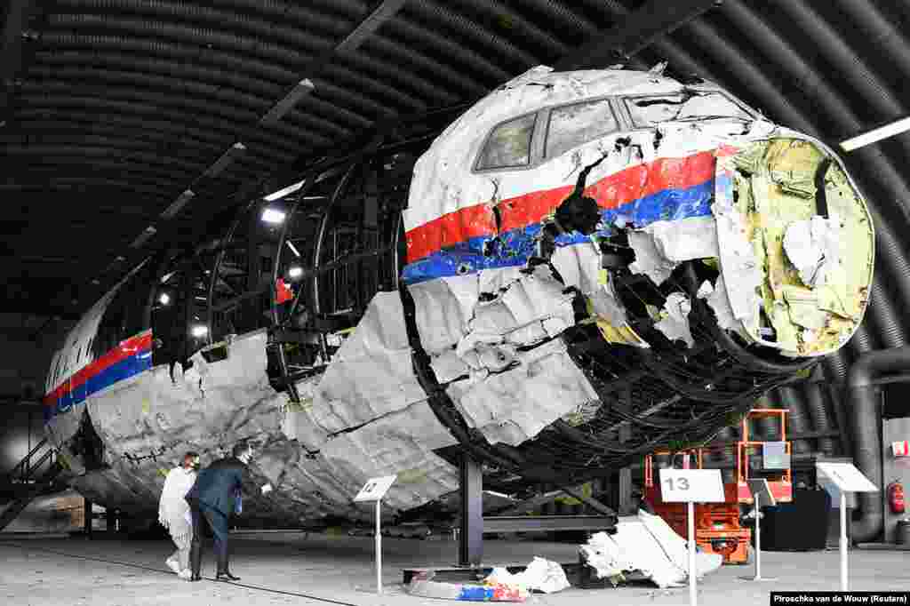 Lawyers inspect the reconstructed shell of Malaysia Airlines Flight 17 at the Gilze-Rijen Air Base in the Netherlands on May 26. 