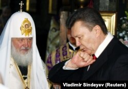 Then-President-elect Viktor Yanukovych kisses his ring during a religious service led by Patriarch Kirill, the head of the Russian Orthodox Church, at the Kyiv-Pechersk Lavra in February 2010.
