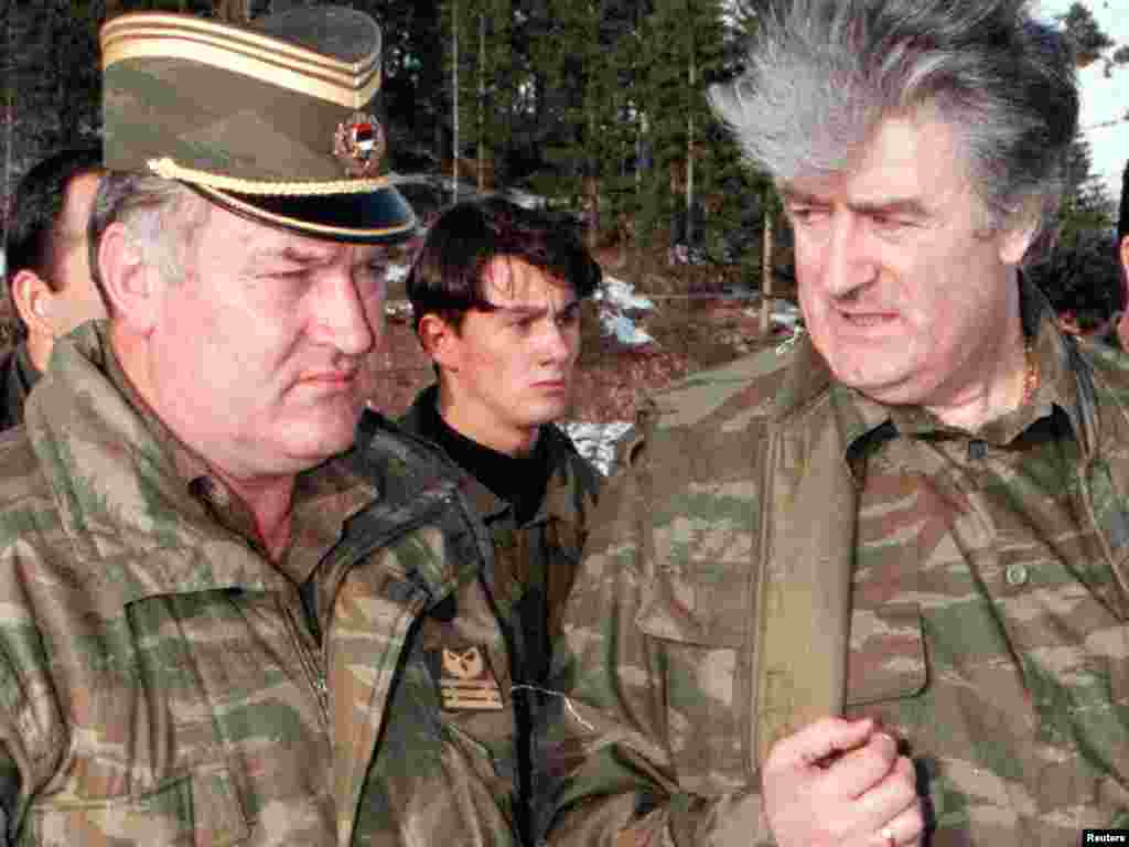 Mladic and former Bosnian Serb leader Radovan Karadzic talk to each other on the Vlasic Mountain in 1995.