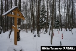 Makeshift memorials to victims in the woods at the Kommunarka memorial site