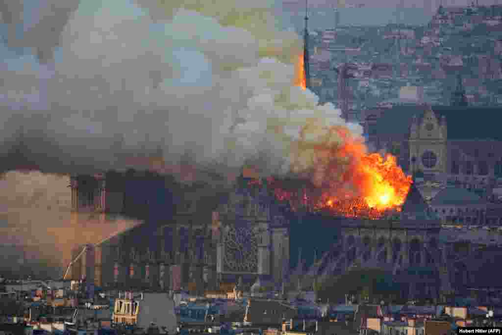 Smoke and flames spew from Notre Dame Cathedral on April 15, 2019.