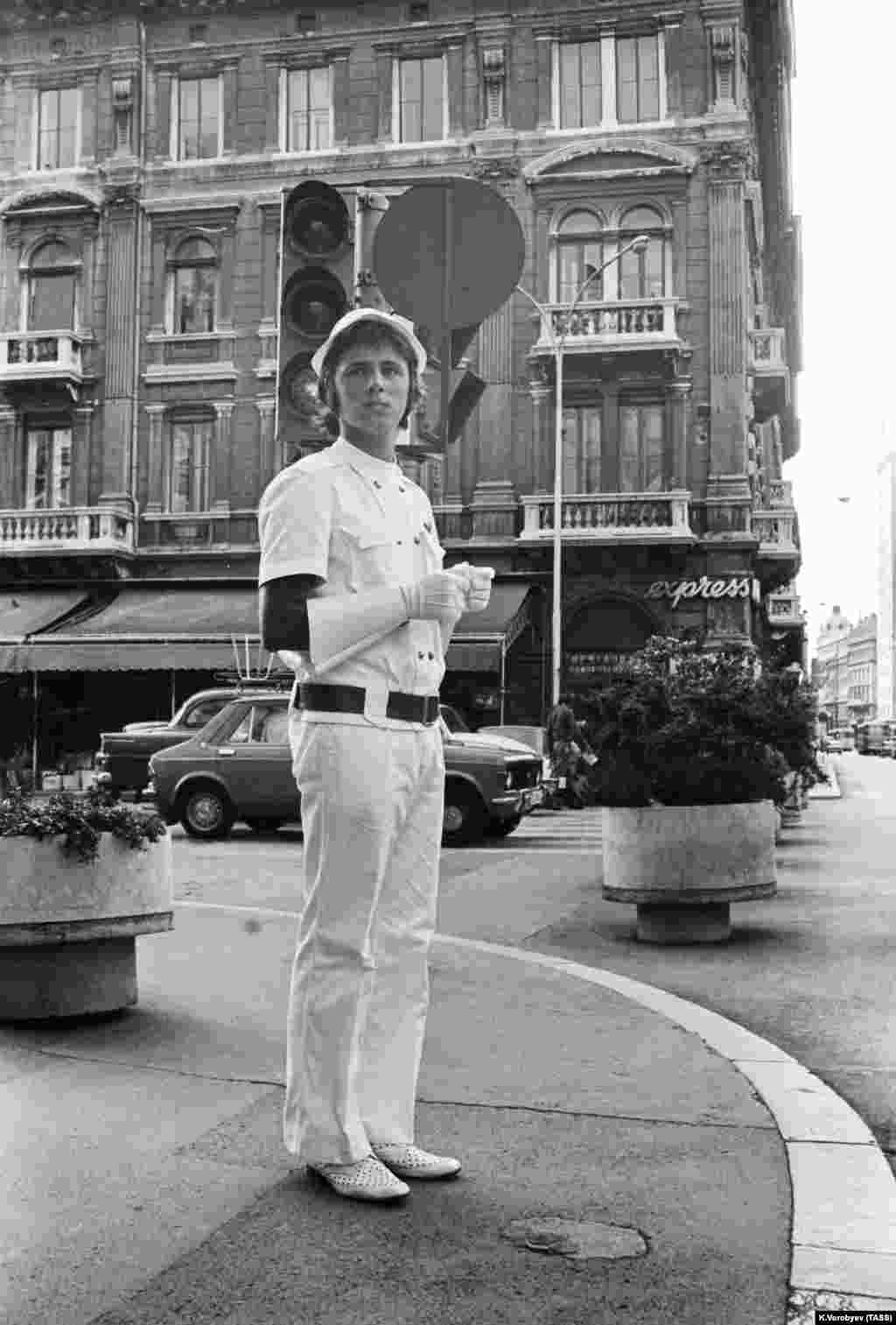 A member of the “volunteer youth squad” on duty in Rijeka, Croatia, as he “monitors public order” in 1975.