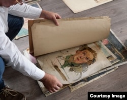 Jakub Sedlacek leafs through some of the work of Gertrud Kauders. He said stories of what happened to Kauders were his first introduction to evil when he was a boy.