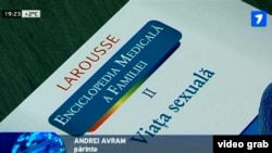 A TV grab shows the cover of a Romanian-language translation of a French reference book titled “A Family Medical Encyclopedia, Vol. II: Sex Life,” during a press conference in the city of Balti on March 13.