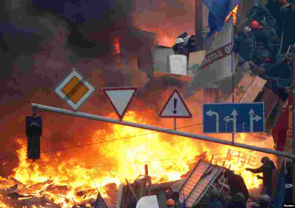 A barricade burns on Independence Square in Kyiv on February 19 after unrest continued throughout the night.