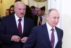 Belarusian President Alyaksandr Lukashenka (left) and his Russian counterpart Vladimir Putin in St. Petersburg last month.