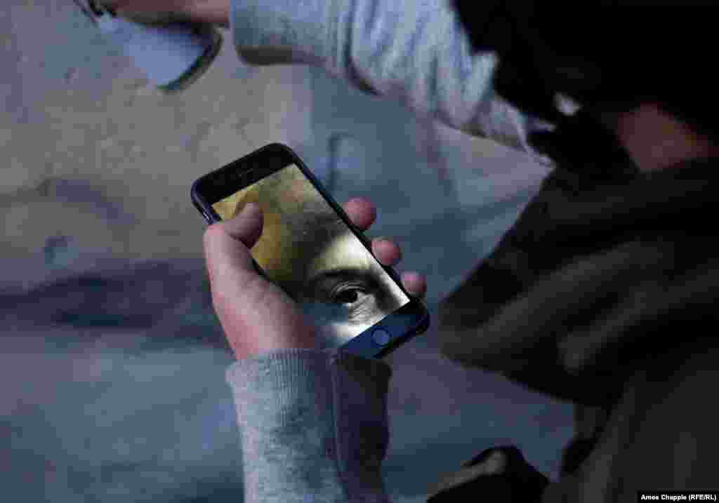 Van Helten using his cellphone as a guide while he paints. The artist says he eventually agreed after feeling &quot;kind of down&quot; while working on an assignment in Finland. &quot;I just thought, as long as people don&#39;t see it [as a daredevil thing] then only good can come out of it.&quot;