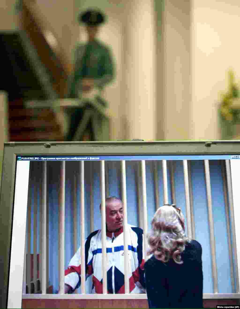 Russian military intelligence officer Sergei Skripal was among the four people released by Russia. A monitor outside a Moscow courtroom shows Skripal speaking to his lawyer during a 2006 trial in which he was convicted of spying for the U.K. After the spy swap, Skripal ended up living in England, where he was poisoned in 2018, allegedly by two Russian suspects. Skripal and his daughter almost died in the attack. Moscow denied accusations that it tried to kill him.