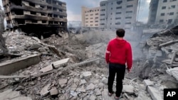 A man looks at destroyed buildings hit by Israeli air strikes in Beirut on the anniversary of the deadly October 7 Hamas attack on Israel.