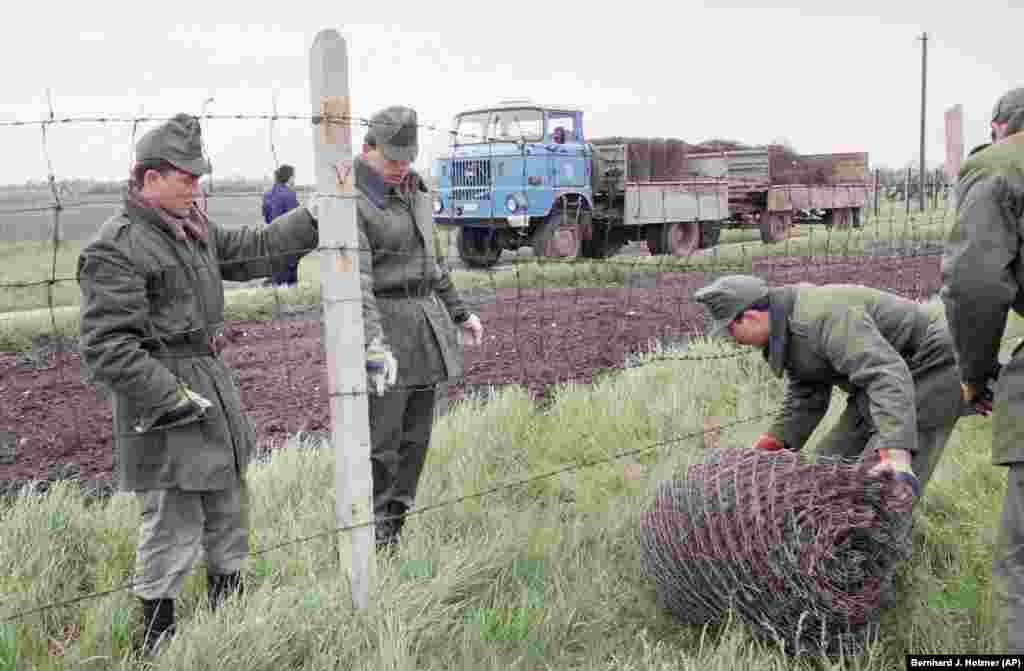 Hungarian border guards pack up the "iron curtain" during its removal from the Austrian border in May 1989. “I erased that item from my budget,” Nemeth later recalled of the decision to dismantle Hungary's border fence with Austria. 