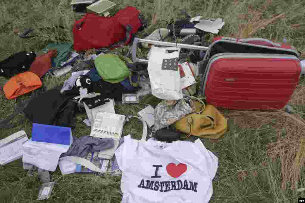 Passengers' personal belongings and luggage amid the debris of the Boeing 777 jet. 