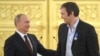Russian President Vladimir Putin (left) greets ice-hockey player Aleksandr Ovechkin after Russia won the men's ice hockey World Championship in 2014. (file photo)