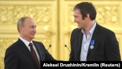 Russian President Vladimir Putin (left) greets ice-hockey player Aleksandr Ovechkin after Russia won the men's ice hockey World Championship in 2014. (file photo)
