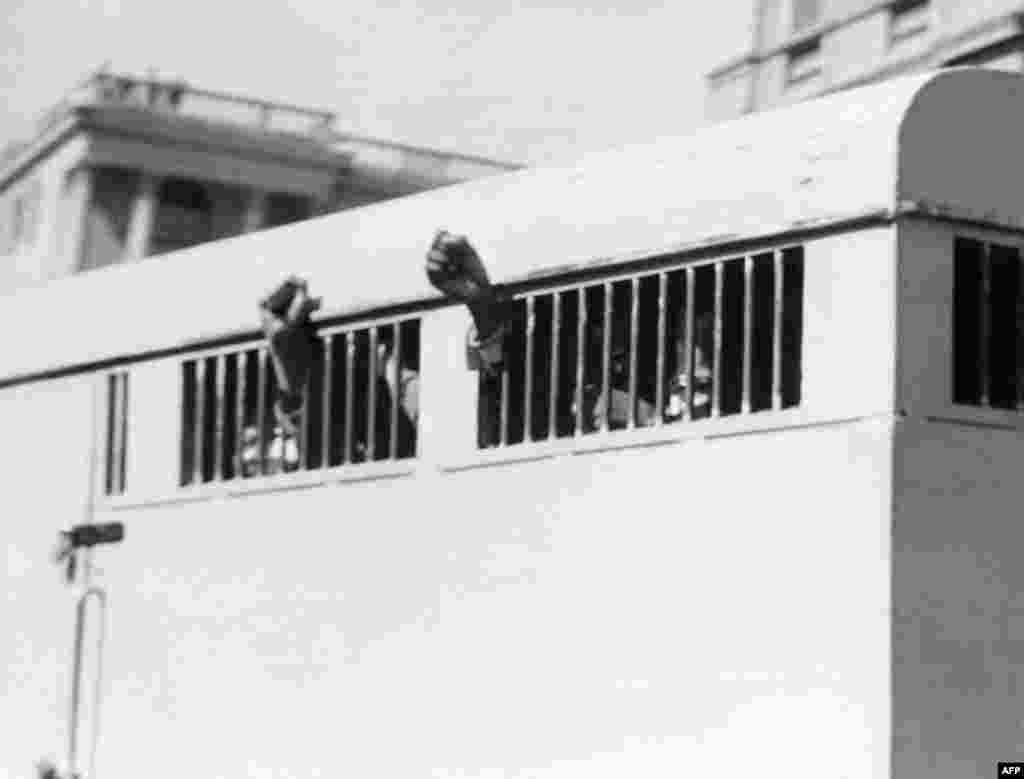 Antiapartheid activists, including Nelson Mandela, make defiant gestures after being sentenced to life imprisonment in Pretoria in 1964.