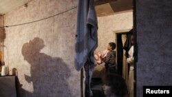 A family of Tajik migrant workers are seen in their house outside Moscow. (file photo)